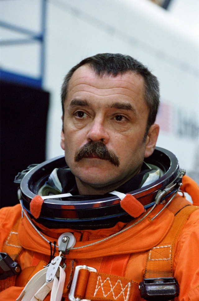 Cosmonaut Mikhail Tyurin, Expedition Three flight engineer, attired in a training version of the shuttle launch and entry garment, is photographed prior to a mission training session in the Systems Integration Facility at Johnson Space Center (JSC). Tyurin, minutes later, was seated along with his crew mates on the mid deck of one of the high fidelity trainers/mockups. Tyurin is affiliated with Rosaviakosmos. The Expedition Three crew is scheduled to launch aboard the Space Shuttle Discovery this summer to begin a lengthy stay onboard the International Space Station (ISS).