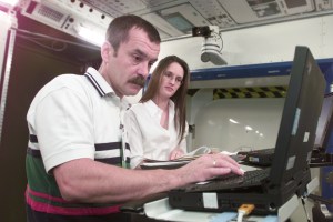 Cosmonaut Mikhail Tyurin, Expedition Three flight engineer representing Rosaviakosmos, assisted by trainer Dea Taylor, is photographed during Human Research Facility (HRF) Rack training in the International Space Station (ISS) Destiny laboratory mockup/trainer at the Johnson Space Center’s Systems Integration Facility.