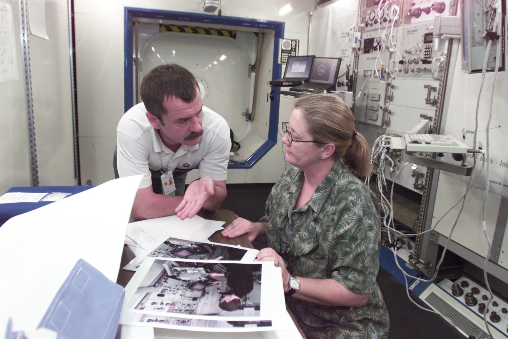 Cosmonaut Mikhail Tyurin, Expedition Three flight engineer representing Rosaviakosmos, is photographed during Human Research Facility (HRF) Rack training in the International Space Station (ISS) Destiny laboratory mockup/trainer at the Johnson Space Center’s Systems Integration Facility. Tyurin is assisted by Glynda Robbins, who works with the training program for assigned crew members.