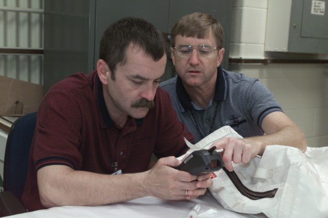 Cosmonaut Mikhail Tyurin (left), Expedition Three flight engineer, and Frank L. Culbertson, Jr., Expedition Three commander, participate in biomedical training in the Bioengineering and Test Support Facility at Johnson Space Center (JSC). Tyurin is affiliated with Rosaviakosmos.