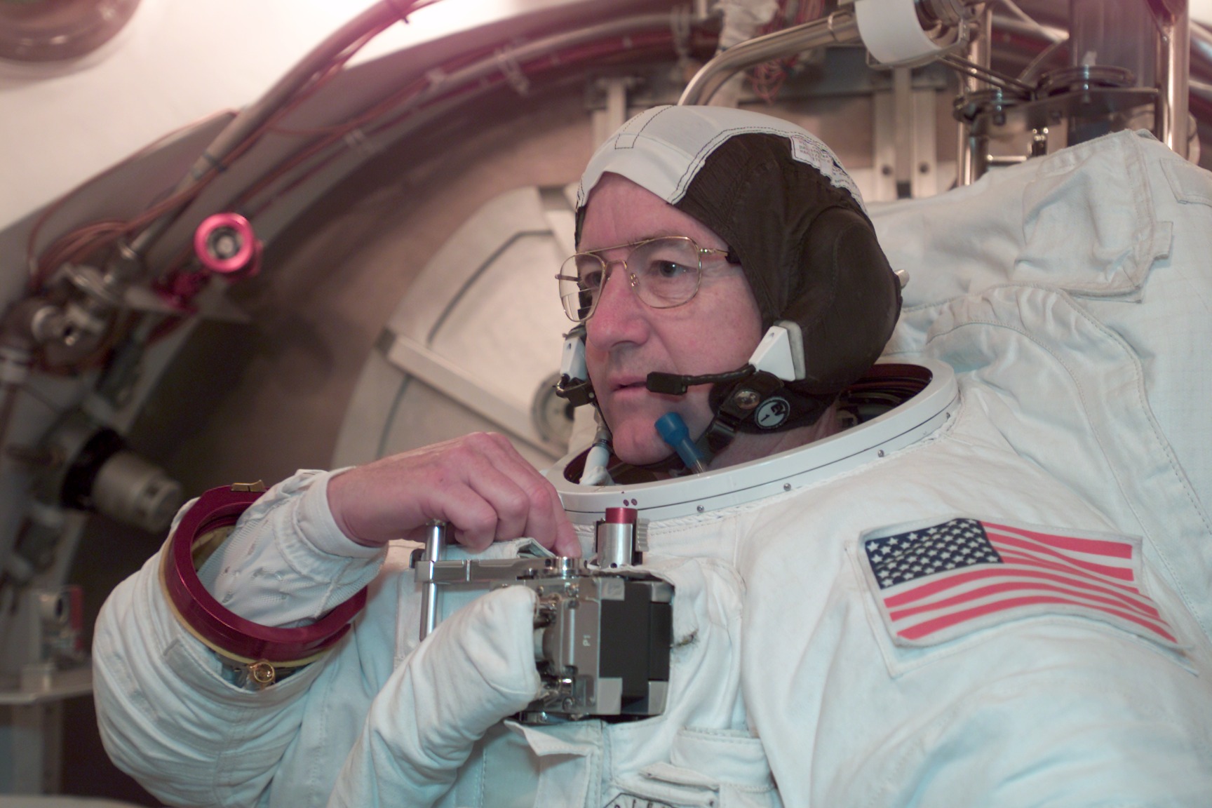 Astronaut Frank L. Culbertson, Jr., Expedition Three commander, participates in an Extravehicular Mobility Unit (EMU) fit check in a Space Station Airlock Test Article (SSATA) in the Crew Systems Laboratory at the Johnson Space Center (JSC).