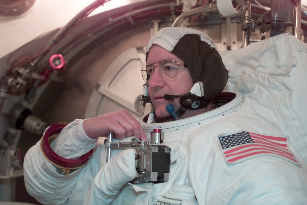 Astronaut Frank L. Culbertson, Jr., Expedition Three commander, participates in an Extravehicular Mobility Unit (EMU) fit check in a Space Station Airlock Test Article (SSATA) in the Crew Systems Laboratory at the Johnson Space Center (JSC).