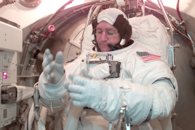 Astronaut Frank L. Culbertson, Jr., Expedition Three commander, participates in an Extravehicular Mobility Unit (EMU) fit check in a Space Station Airlock Test Article (SSATA) in the Crew Systems Laboratory at the Johnson Space Center (JSC).