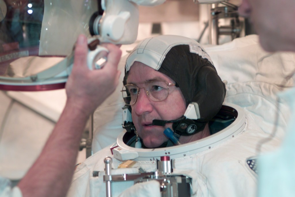 Astronaut Frank L. Culbertson, Jr., Expedition Three commander, participates in an Extravehicular Mobility Unit (EMU) fit check in a Space Station Airlock Test Article (SSATA) in the Crew Systems Laboratory at the Johnson Space Center (JSC).