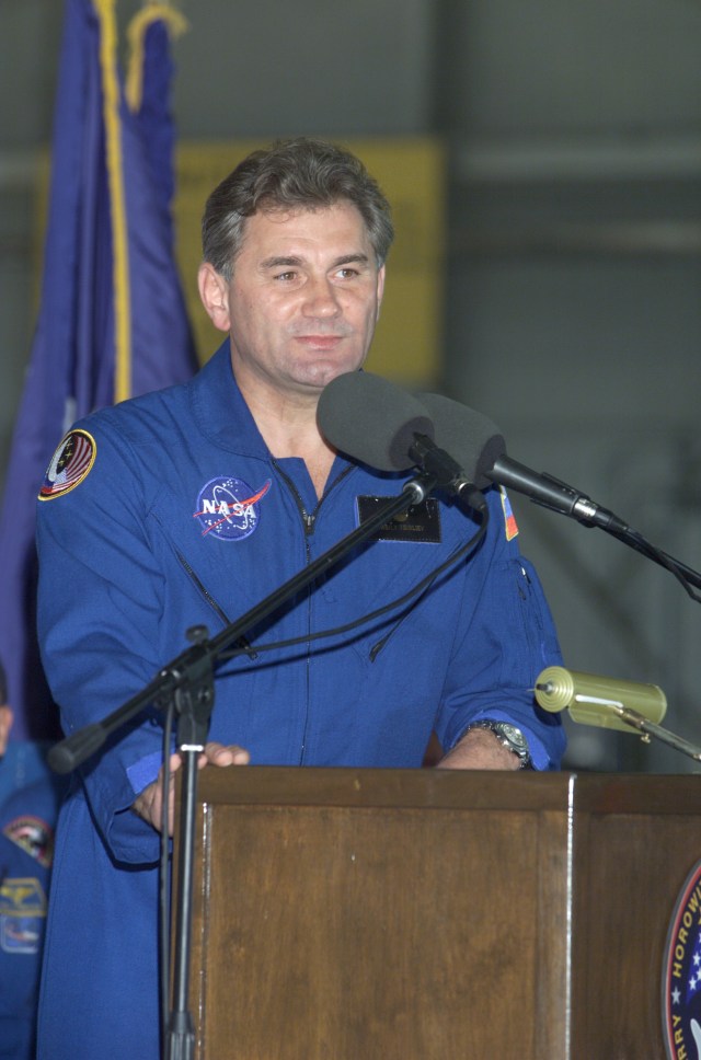 JSC2001-E-25811 (23 August 2001) --- Vasili V. Tsibliyev of Rosaviakosmos speaks from the podium in Hangar 990 at Ellington Field during the STS-105 and Expedition Two crew return ceremonies.
