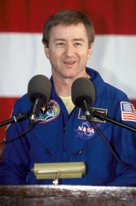 Astronaut Frank L. Culbertson, Jr., Expedition Three mission commander, speaks from the podium in Hangar 990 at Ellington Field during the STS-108 and Expedition Three crew return ceremonies. The STS-108 crew delivered the Expedition Four crew and supplies to the International Space Station (ISS) and brought the Expedition Three crew back to Earth.