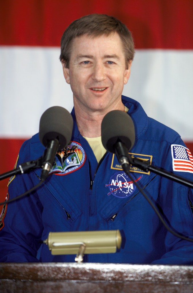 Astronaut Frank L. Culbertson, Jr., Expedition Three mission commander, speaks from the podium in Hangar 990 at Ellington Field during the STS-108 and Expedition Three crew return ceremonies. The STS-108 crew delivered the Expedition Four crew and supplies to the International Space Station (ISS) and brought the Expedition Three crew back to Earth.