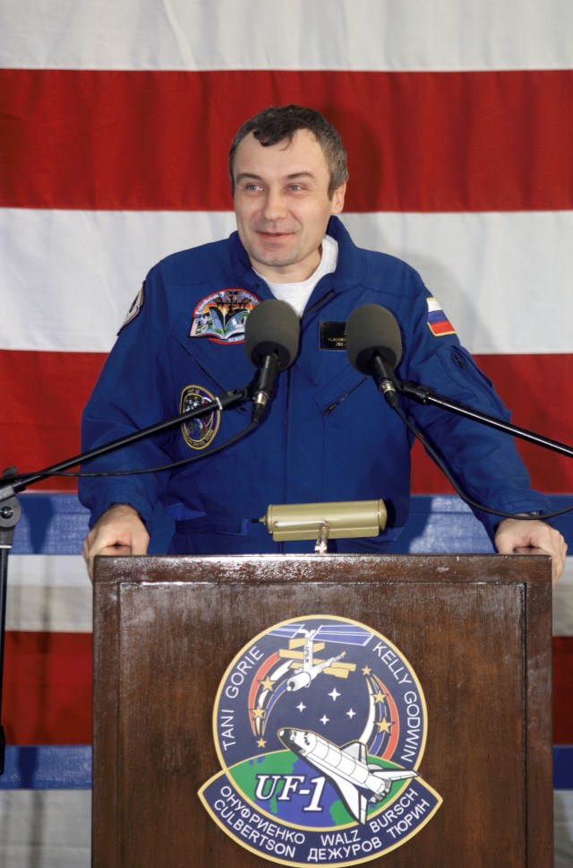 Cosmonaut Vladimir N. Dezhurov, Expedition Three flight engineer representing Rosaviakosmos, speaks from the podium in Hangar 990 at Ellington Field during the STS-108 and Expedition Three crew return ceremonies. The STS-108 crew delivered the Expedition Four crew and supplies to the International Space Station (ISS) and brought the Expedition Three crew back to Earth.