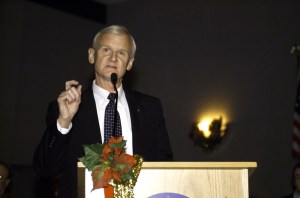 John H. Casper, Director of Safety, Reliability, and Quality Assurance Office, speaks from the lectern in the ballroom of the Gilruth Center at Johnson Space Center (JSC) during the Expedition Three Welcome Home ceremony.