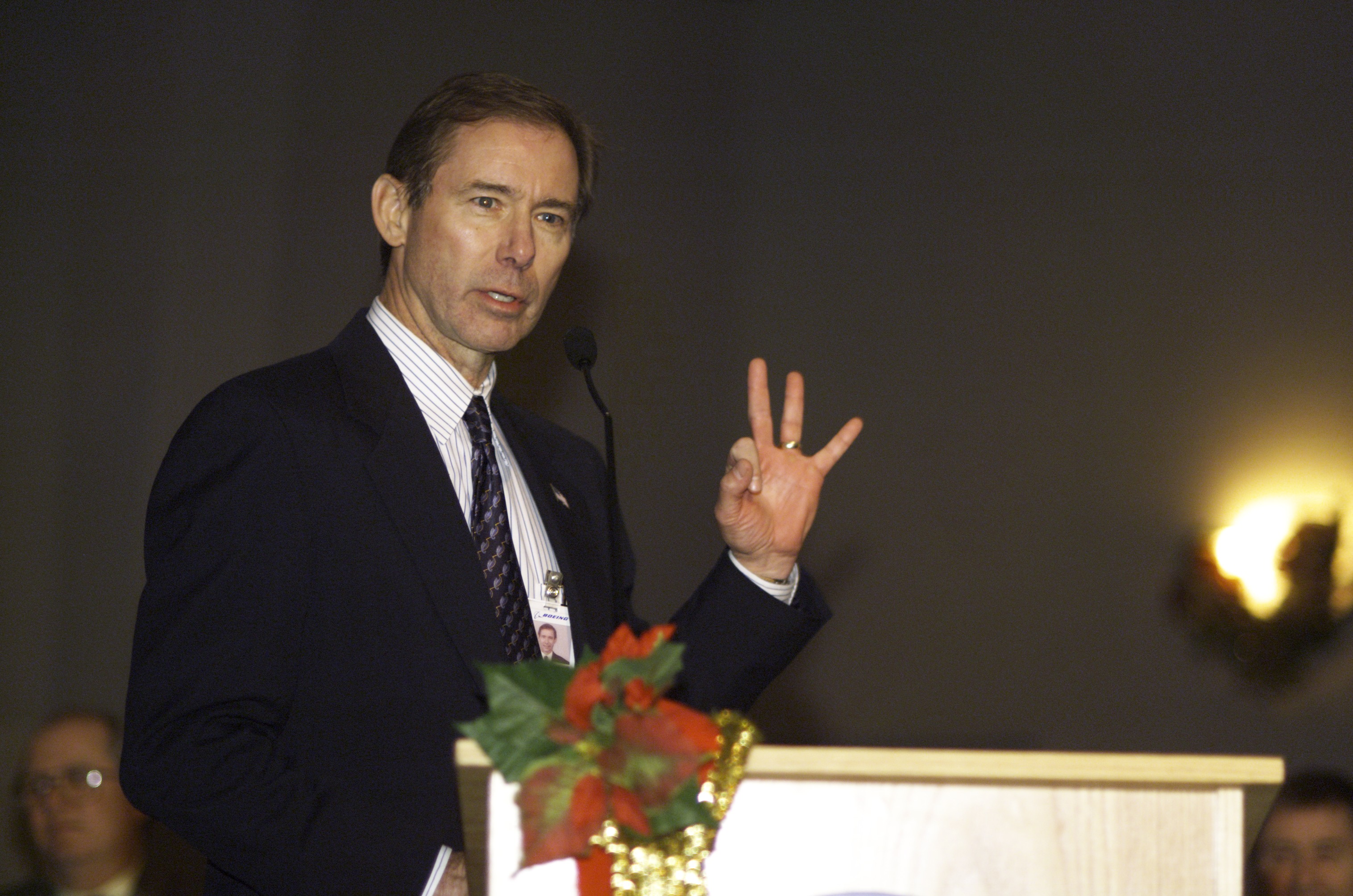 Former astronaut Brewster H. Shaw, now with Boeing, speaks from the lectern in the ballroom of the Gilruth Center at Johnson Space Center (JSC) during the Expedition Three Welcome Home ceremony.