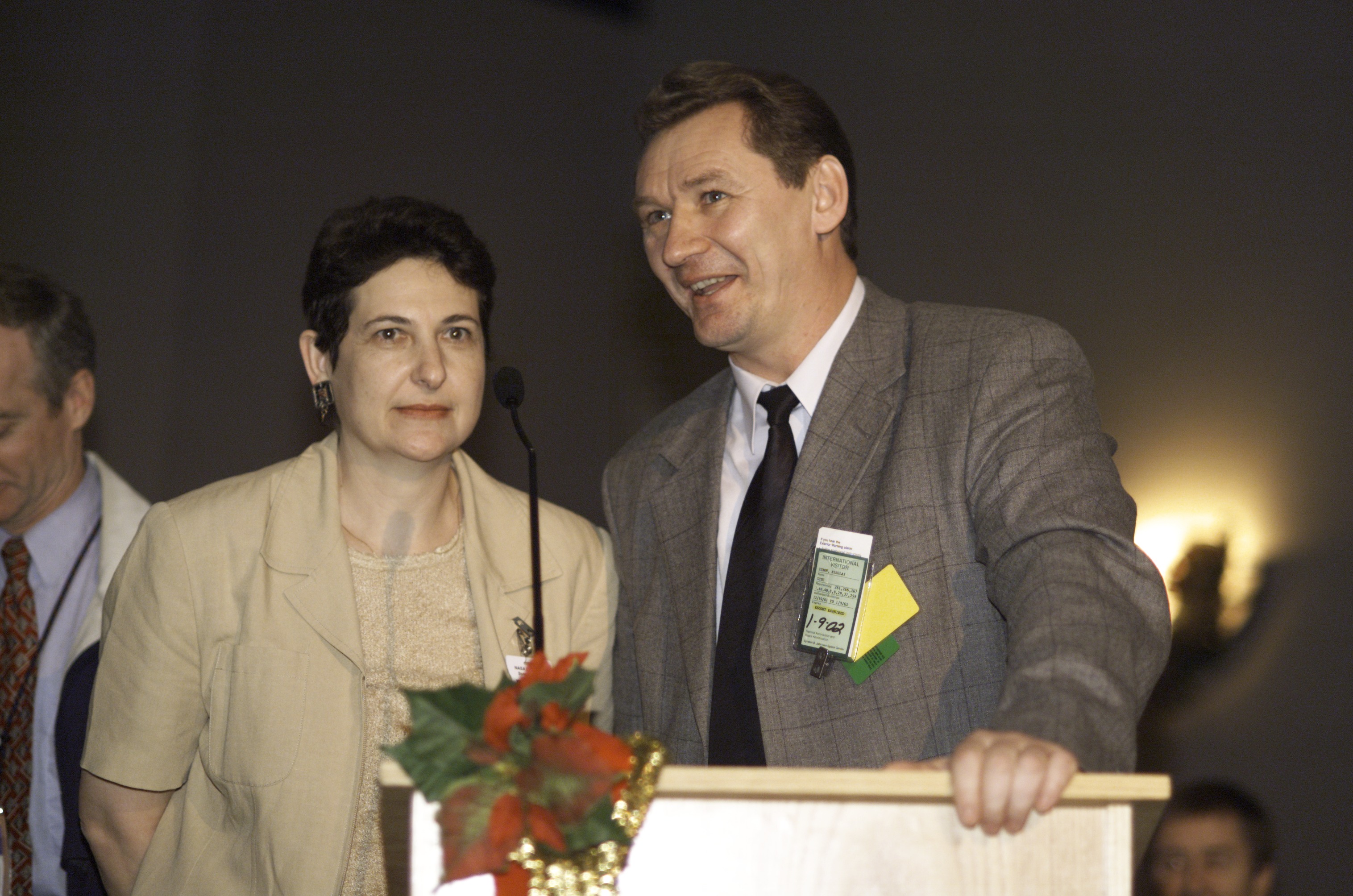 Nikolai Zubov, Deputy Director for Logistics and Procurement, Gagarin Cosmonaut Training Center at Star City, Russia, assisted by an interpreter, speaks from the lectern in the ballroom of the Gilruth Center at Johnson Space Center (JSC) during the Expedition Three Welcome Home ceremony.