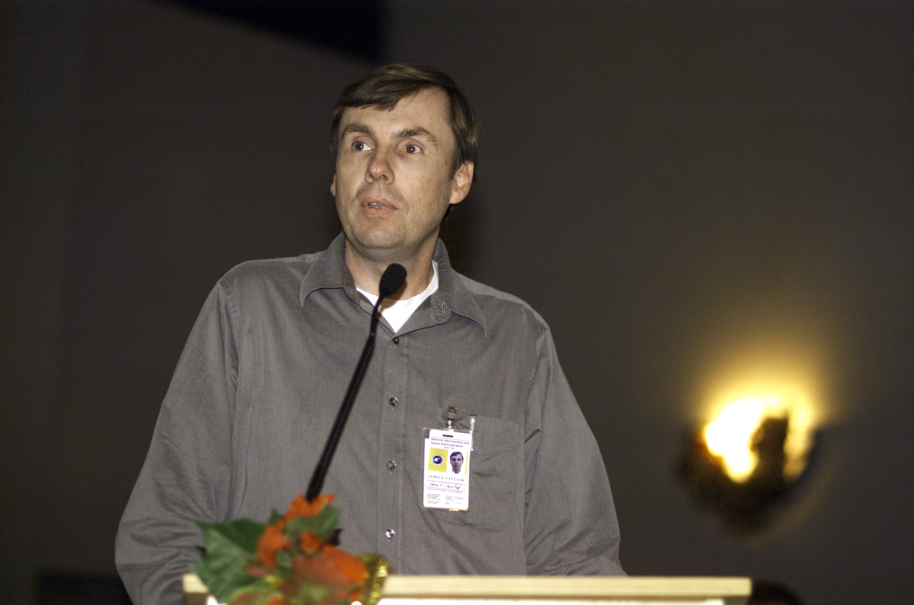 James E. Van Laak, Manager, Operations Integration of International Space Station Program, speaks from the lectern in the ballroom of the Gilruth Center at Johnson Space Center (JSC) during the Expedition Three Welcome Home ceremony.