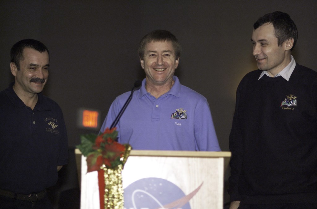 Astronaut Frank L. Culbertson, Jr., Expedition Three mission commander, flanked by cosmonauts Mikhail Tyurin (left) and Vladimir N. Dezhurov, both flight engineers, speak from the lectern in the ballroom of the Gilruth Center at Johnson Space Center (JSC) during the Expedition Three Welcome Home ceremony. Tyurin and Dezhurov represent Rosaviakosmos.