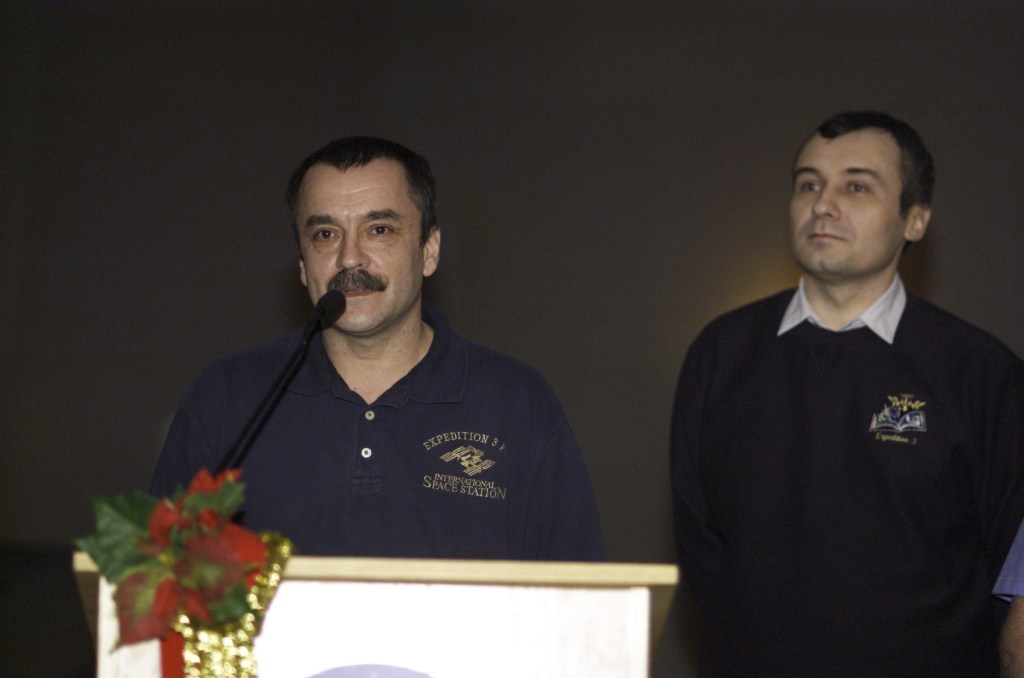 Cosmonaut Mikhail Tyurin, joined by cosmonaut Vladimir N. Dezhurov, both Expedition Three flight engineers representing Rosaviakosmos, speaks from the lectern in the ballroom of the Gilruth Center at Johnson Space Center (JSC) during the Expedition Three Welcome Home ceremony.