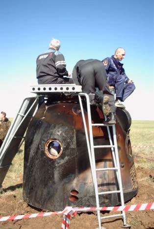 Technicians prepare the Soyuz TM-33 spacecraft for removal from the Kazakhstan landing site where the Soyuz 4 taxi mission earlier had come to a successful ending. The Soyuz touched down at 7:52 a.m. Moscow time. Photo Credit: NASA/Marty Linde