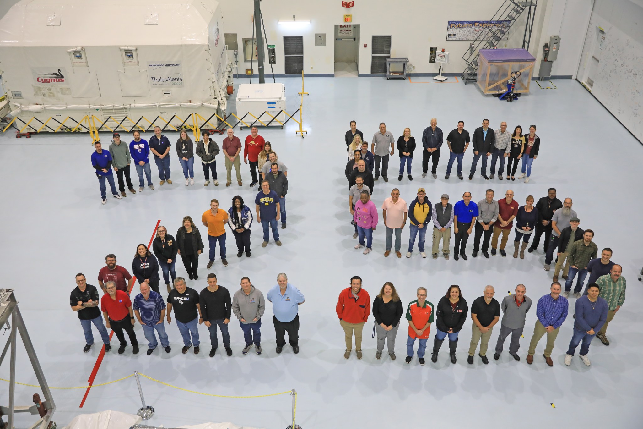 Teams at the Space Station Processing Facility at NASA’s Kennedy Space Center in Florida celebrate 25 years of supporting the International Space Station on November 28, 2023.