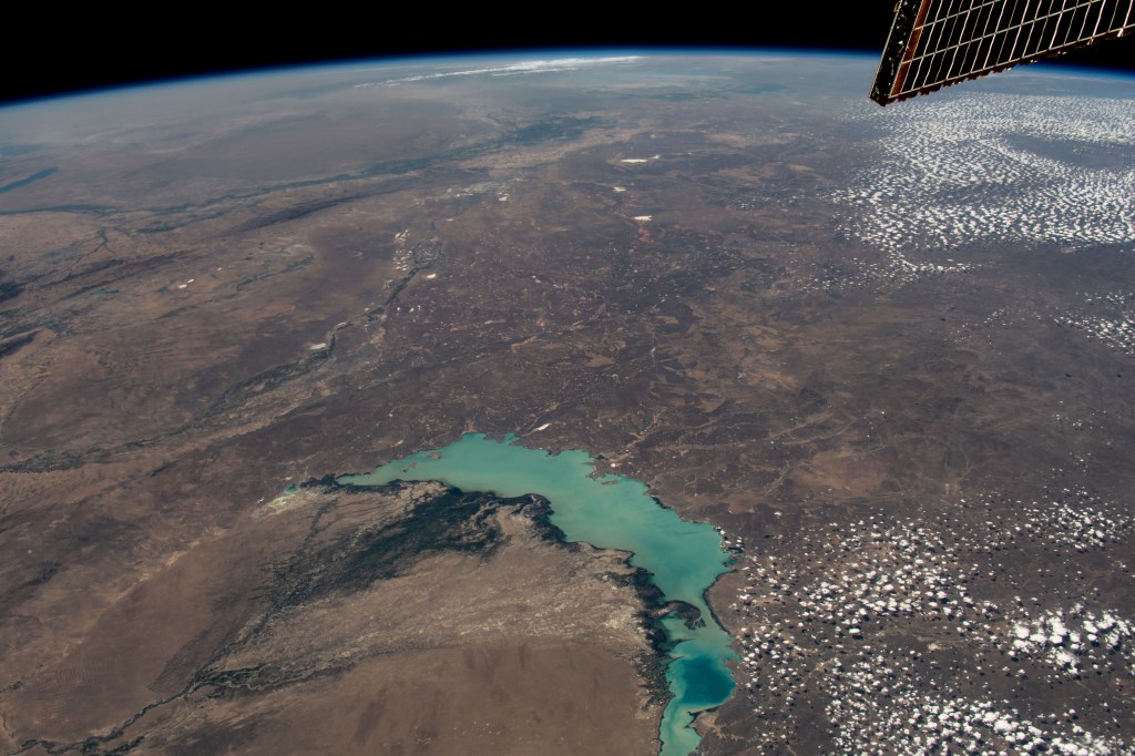 Lake Balkhash, one of the largest in Central Asia, spans roughly 6,500 square miles (17,000 square kilometers) in Kazakhstan. The western part of the lake holds fresh water whereas the eastern side of the basin is salty. The International Space Station soared 261 miles above as this image was taken.