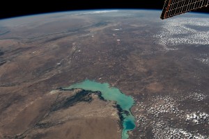 Lake Balkhash, one of the largest in Central Asia, spans roughly 6,500 square miles (17,000 square kilometers) in Kazakhstan. The western part of the lake holds fresh water whereas the eastern side of the basin is salty. The International Space Station soared 261 miles above as this image was taken.