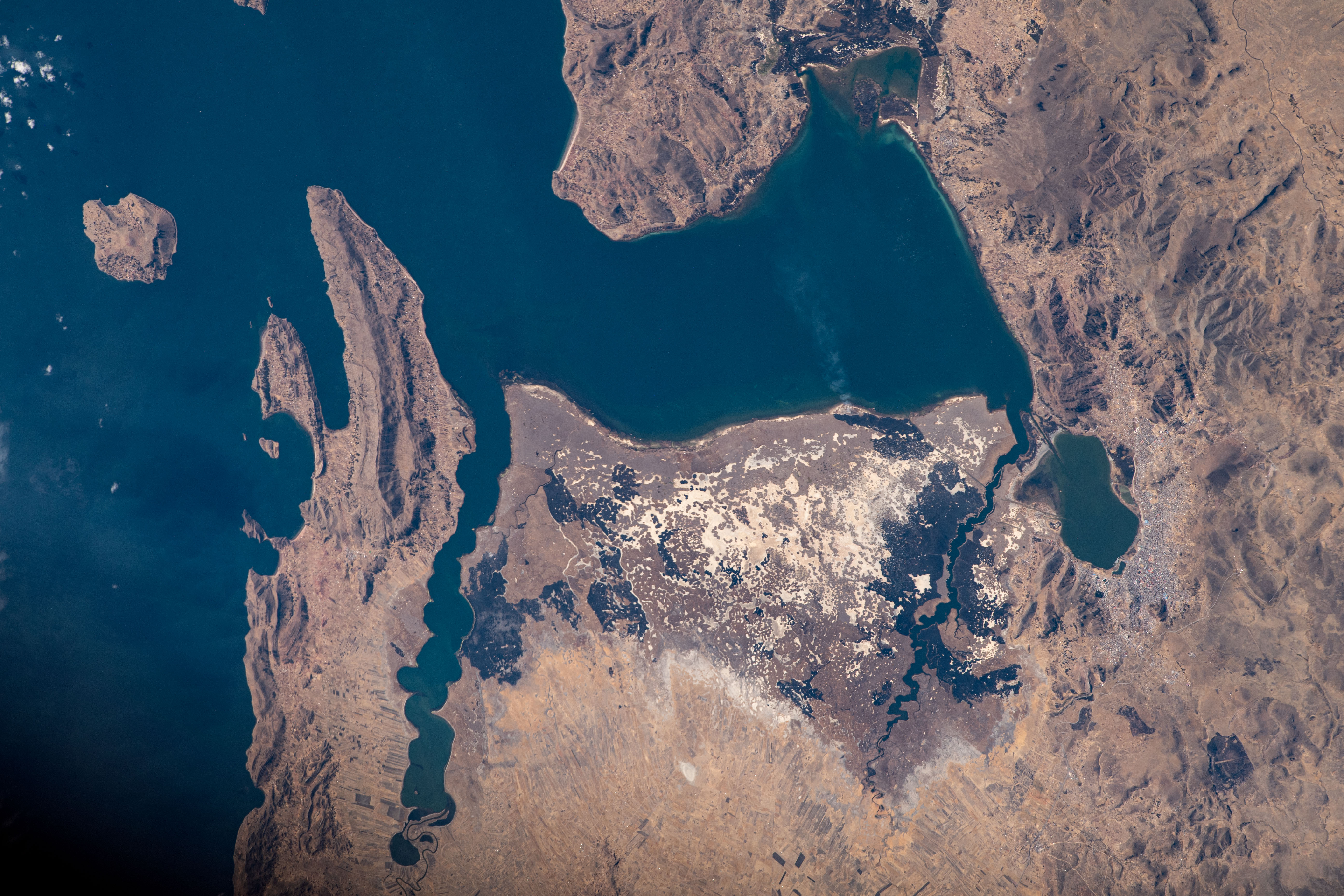 Lake Titicaca, the highest major body of navigable water in the world, borders Peru and Bolivia in the Andes Mountain region. It's the largest lake in South America, fed by glacial rivers draining into the body of water. As the International Space Station orbited roughly 260 miles above, NASA astronaut Jasmin Moghbeli captured this image.