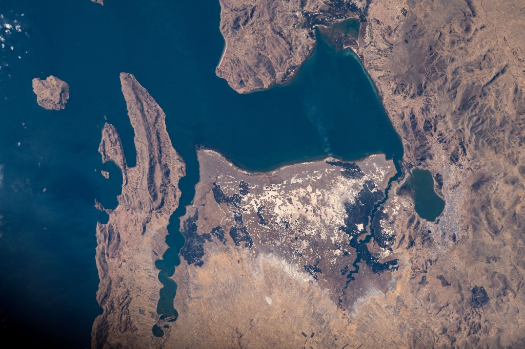 Lake Titicaca, the highest major body of navigable water in the world, borders Peru and Bolivia in the Andes Mountain region. It's the largest lake in South America, fed by glacial rivers draining into the body of water. As the International Space Station orbited roughly 260 miles above, NASA astronaut Jasmin Moghbeli captured this image.