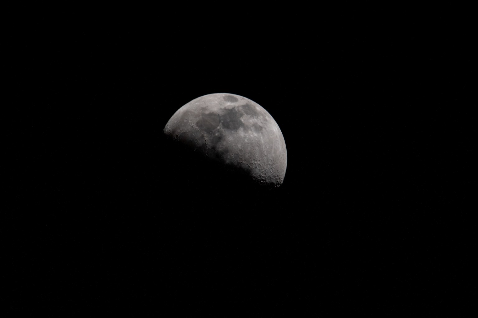 Earth's Moon in first quarter phase as United Arab Emirates (UAE) Flight Engineer Sultan Alneyadi captured this photo aboard the International Space Station.