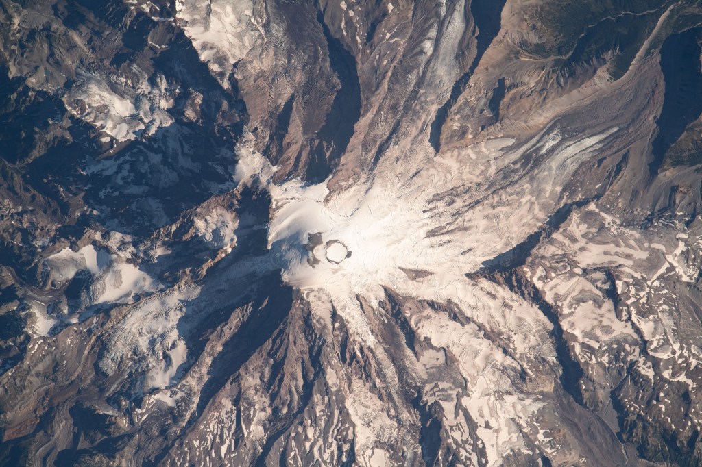Mount Rainier, an active volcano with an elevation of 14,400 feet, is pictured from the International Space Station as it orbited 264 miles above the Evergreen State of Washington.