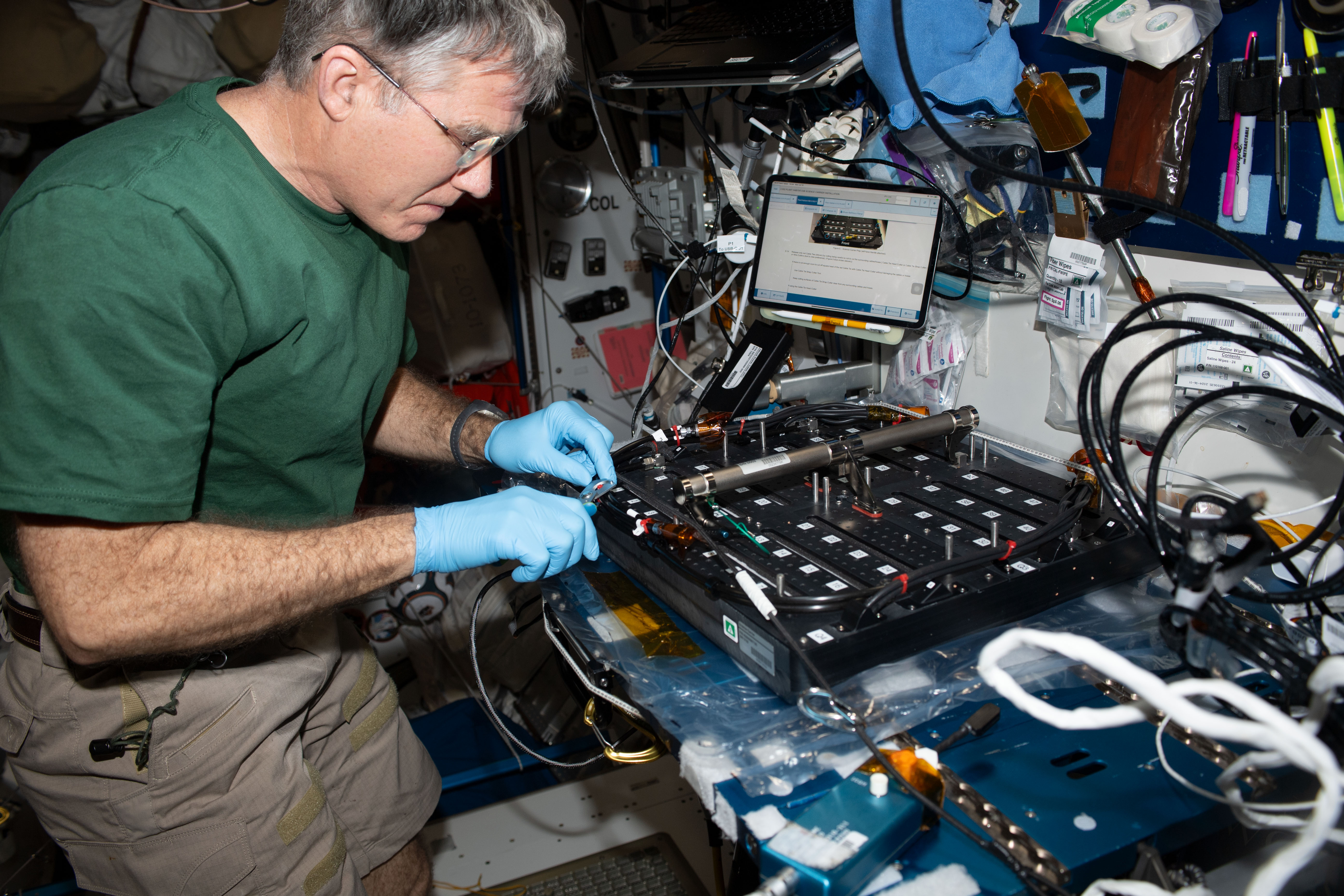 NASA astronaut and Expedition 69 Flight Engineer Stephen Bowen works on the Plant Habitat-03B Science Carrier, a space botany research device, in the International Space Station's Harmony module. The Plant Habitat-03 investigation explores how space-caused DNA changes are transferred from one generation of plants to the next and then continue to accumulate or stabilize. This could provide insight into how to grow repeated generations of crops to provide food and other services on future space missions.