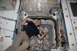 NASA astronaut and Expedition 69 Flight Engineer Woody Hoburg poses for a portrait inside the vestibule that separates the Unity module from the Northrop Grumman Cygnus space freighter's hatch.
