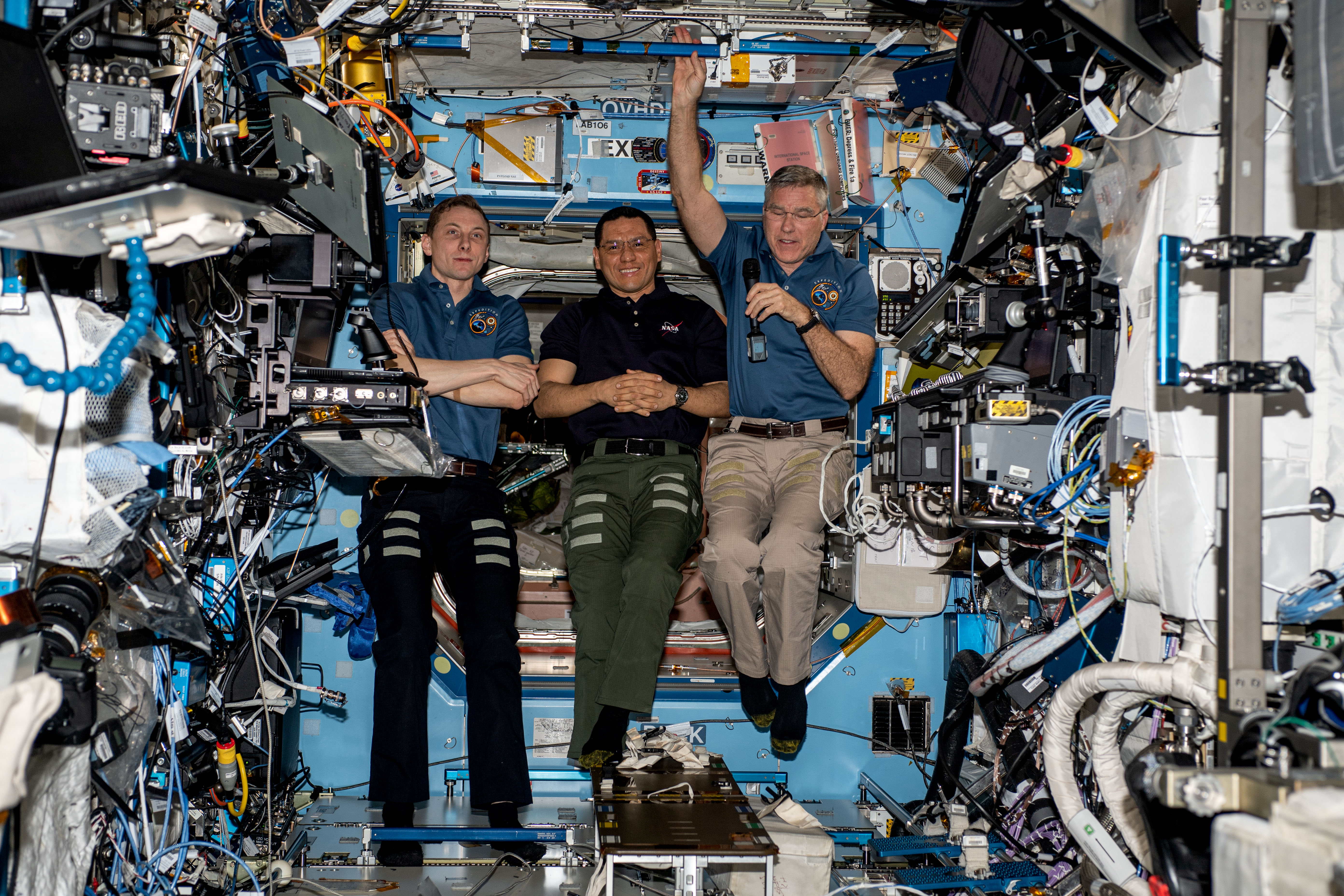Expedition 69 Flight Engineers Woody Hoburg, Frank Rubio, and Stephen Bowen, all from NASA, gather inside the International Space Station's Destiny laboratory module and speak to U.S. elementary and junior high school students on Earth.