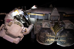 NASA astronaut Stepehen Bowen is pictured readying a roll-out solar array before installating it on the International Space Station's Starboard-6 truss structure.