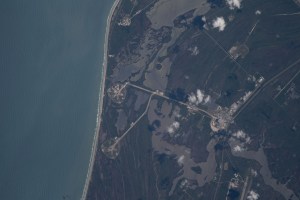 The International Space Station was orbiting just off the coast of Cape Canaveral, Florida, about 260 miles above the Atlantic Ocean when Expedition 67 Flight Engineer Raja Chari photographed NASA's Kennedy Space Center. The agency's two launch pads, 39A (at top) and 39B (at bottom), are clearly seen on the beach. Standing at launch pad 39B is NASA's Space Launch System (SLS) rocket with the Orion spacecraft atop. The rocket is being prepared for the uncrewed Artemis I mission "that will demonstrate NASA’s commitment and capacity to extend humanity’s presence on the Moon – and beyond."
