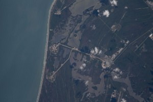 The International Space Station was orbiting just off the coast of Cape Canaveral, Florida, about 260 miles above the Atlantic Ocean when Expedition 67 Flight Engineer Raja Chari photographed NASA's Kennedy Space Center. The agency's two launch pads, 39A (at top) and 39B (at bottom), are clearly seen on the beach. Standing at launch pad 39B is NASA's Space Launch System (SLS) rocket with the Orion spacecraft atop. The rocket is being prepared for the uncrewed Artemis I mission "that will demonstrate NASA’s commitment and capacity to extend humanity’s presence on the Moon – and beyond."