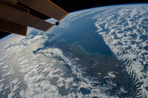 New Zealand, with its snow-capped Southern Alps mountain range, is pictured between two partly cloudy bodies of water, the Tasman Sea and the Pacific Ocean, as the International Space Station orbited 271 miles above.