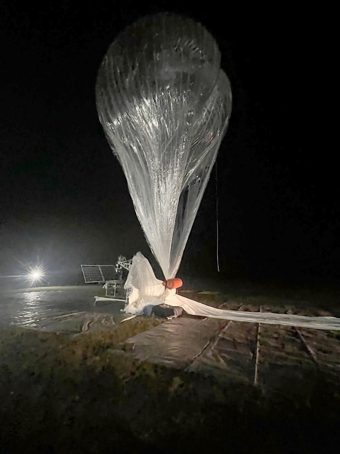 Aerostar balloon on the tarmac at night.