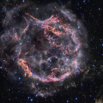 NASA’s James Webb Space Telescope’s new view of Cassiopeia A in near-infrared light is giving astronomers hints at the dynamical processes occurring within the supernova remnant. Tiny clumps represented in bright pink and orange make up the supernova’s inner shell, and are comprised of sulfur, oxygen, argon, and neon from the star itself. A large, striated blob at the bottom right corner of the image, nicknamed Baby Cas A, is one of the few light echoes visible NIRCam’s field of view. In this image, red, green, and blue were assigned to Webb’s NIRCam data at 4.4, 3.56, and 1.62 microns (F444W, F356W, and F162M, respectively).