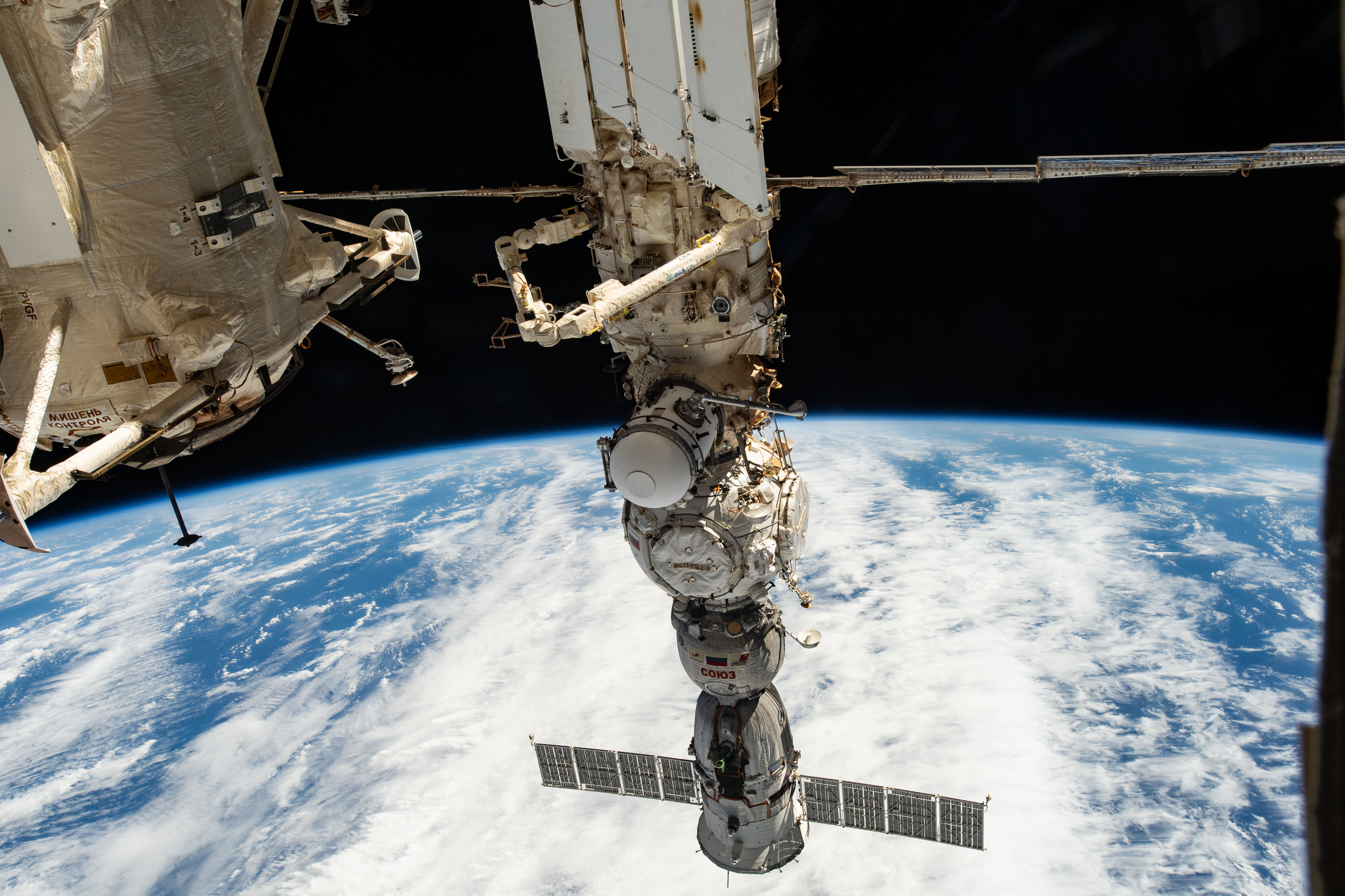 Four main components on the Roscosmos segment of the International Space Station are pictured as the orbital outpost soared 265 miles above a cloudy Pacific Ocean. From top to bottom, are the Nauka multipurpose laboratory module, the European robotic arm attached to Nauka, the Prichal docking module, and the Soyuz MS-23 crew ship.