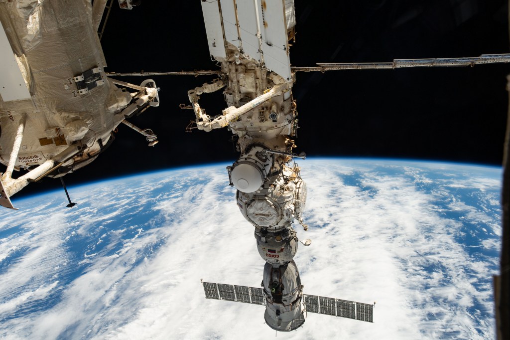 Four main components on the Roscosmos segment of the International Space Station are pictured as the orbital outpost soared 265 miles above a cloudy Pacific Ocean. From top to bottom, are the Nauka multipurpose laboratory module, the European robotic arm attached to Nauka, the Prichal docking module, and the Soyuz MS-23 crew ship.