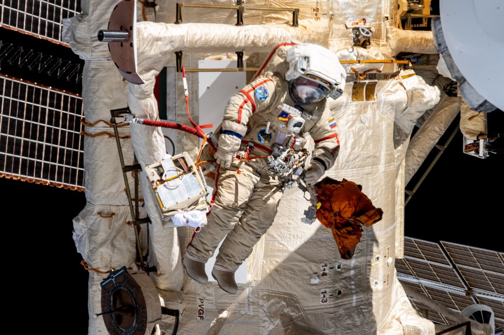 Roscosmos spacewalker Sergey Prokopyev works outside the International Space Station's Roscosmos segment during the installation of an experiment airlock on the Nauka multipurpose laboratory module.