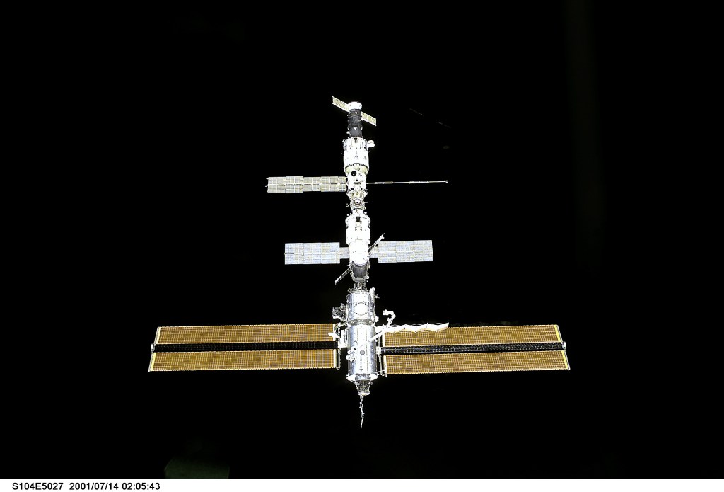 The International Space Station (ISS), with the Expedition Two crew onboard, awaits its rendezvous with the Space Shuttle Atlantis. The picture was made with a digital still camera from the shuttle's aft flight deck.