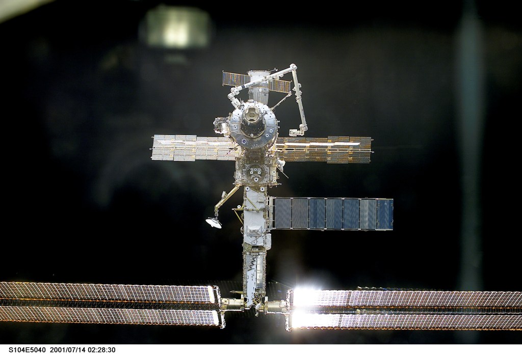The International Space Station (ISS) almost fills this digital still camera's frame as the Space Shuttle Atlantis closes in for docking.