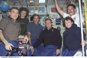 Soon after their ingress into the International Space Station (ISS), STS-104 crewmembers pose for a photograph with Expedition Two crewmembers in the Zvezda Service Module. From left to right are: James S. Voss, Expedition Two flight engineer; Susan J. Helms, Expedition Two flight engineer; Michael L. Gernhardt, STS-104 mission specialist; Steven W. Lindsey, STS-104 mission commander; Janet L. Kavandi, STS-104 mission specialist; and James F. Reilly, STS-104 mission specialist.