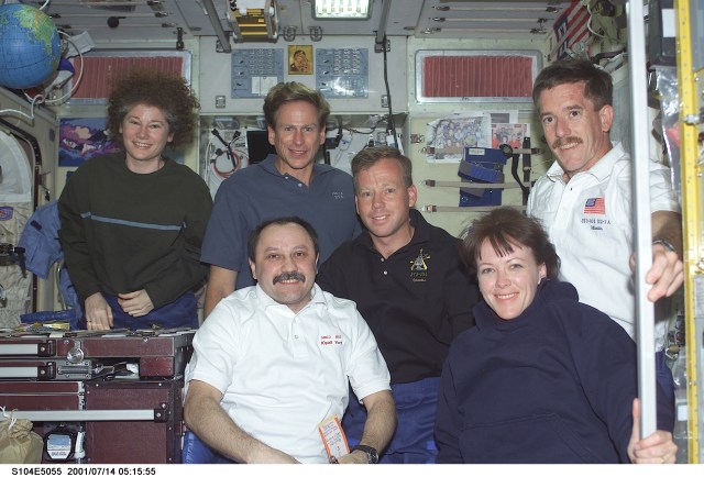 Soon after their ingress into the International Space Station (ISS), STS-104 crewmembers pose for a photograph with Expedition Two crewmembers in the Zvezda Service Module. From left to right are: back row - Susan J. Helms, Expedition Two flight engineer; Michael L. Gernhardt, STS-104 mission specialist; Steven W. Lindsey, STS-104 mission commander; James F. Reilly, STS-104 mission specialist; front row - Yury V. Usachev, Expedition Two mission commander; and Janet L. Kavandi, STS-104 mission specialist. Usachev represents Rosaviakosmos.