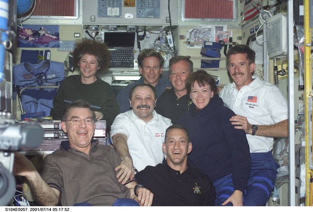Soon after their ingress into the International Space Station (ISS), the STS-104 crewmembers pose for a photograph with the Expedition Two crewmembers in the Zvezda Service Module. From left to right are: back row - Susan J. Helms, Expedition Two flight engineer; Michael L. Gernhardt, STS-104 mission specialist; Steven W. Lindsey, STS-104; James F. Reilly, STS-104 mission specialist; middle row - Yury V. Usachev, Expedition Two mission commander; Janet L. Kavandi, STS-104 mission specialist; front row - James S. Voss, Expedition Two flight engineer; and Charles O. Hobaugh, STS-104 pilot. Usachev represents Rosaviakosmos.