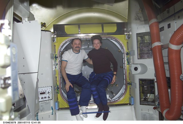 Cosmonaut Yury V. Usachev, Expedition Two mission commander, and Janet L. Kavandi, STS-104 mission specialist, pose in front of the crewlock endcone of the newly installed Quest Airlock. Usachev represents Rosaviakosmos.