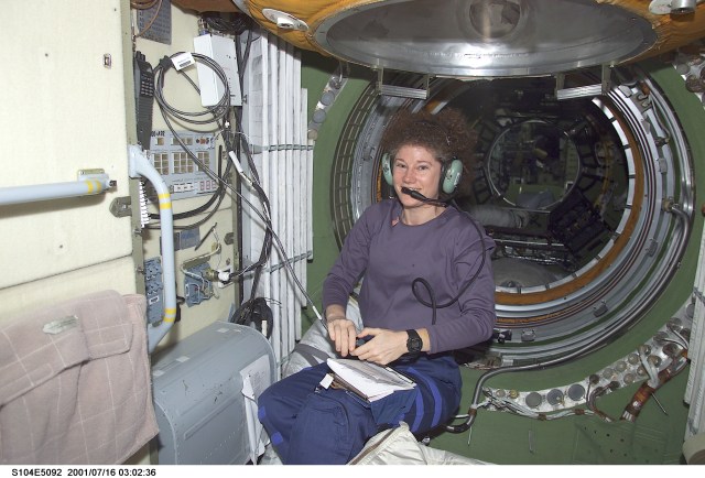 Susan J. Helms, Expedition Two flight engineer, talks to amateur radio operators on Earth from the HAM radio workstation in the Zarya module of the International Space Station (ISS).