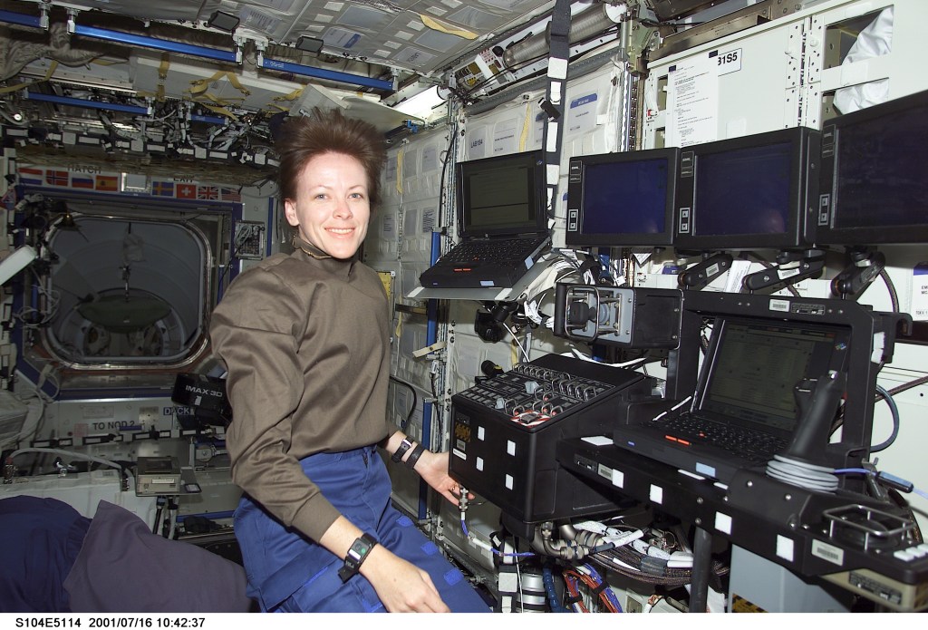 Janet L. Kavandi, STS-104 mission specialist, looks over the Canadarm2, Space Station Remote Manipulator System (SSRMS), control station in the Destiny laboratory during STS-104's visit to the International Space Station (ISS).
