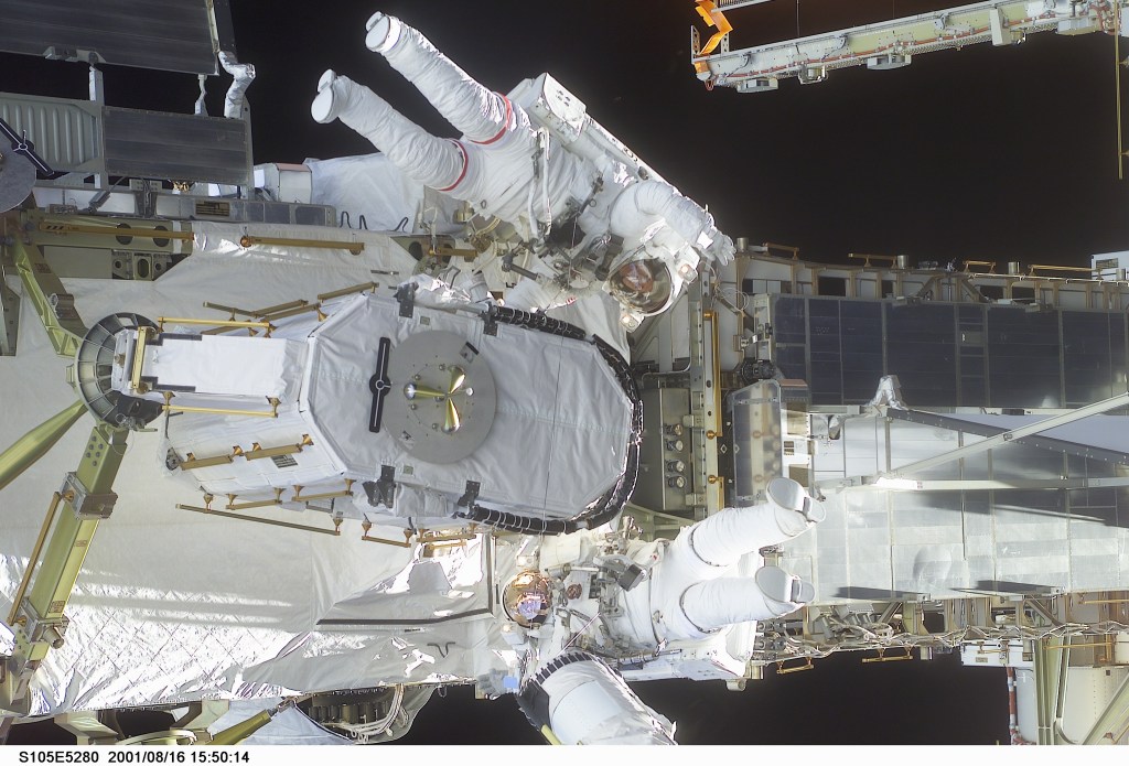 STS105-E-5280 (16 August 2001) --- Astronauts Daniel T. Barry (with red stripes on suit) and Patrick G. Forrester work with the Early Ammonia Servicer (EAS), which they are in the process of installing on a segment of the P6 structure on the International Space Station (ISS). The two mission specialists were participating in the first of two scheduled STS-105 space walks. The image was recorded with a digital still camera.