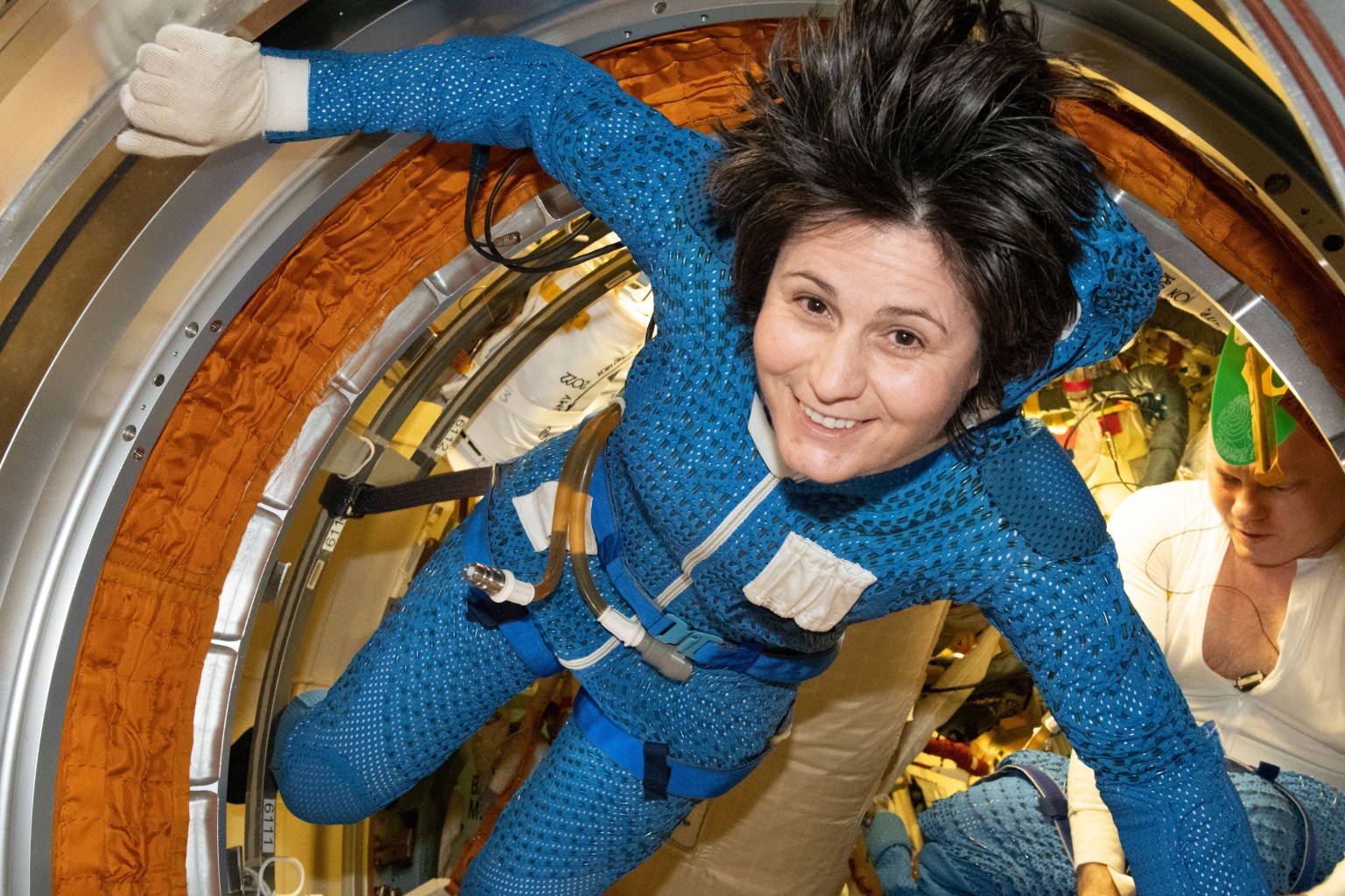 Expedition 67 Flight Engineer Samantha Cristoforetti of ESA (European Space Agency) is pictured inside the International Space Station's Poisk module preparing for a spacewalk. She and Expedition 67 Commander Oleg Artemyev (rear) would exit the Poisk airlock to continue the outfitting of the European robotic arm attached to Nauka during a spacewalk that lasted seven hours and five minutes.
