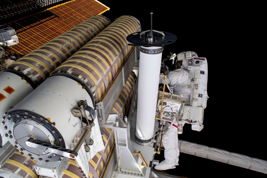 NASA astronaut and Expedition 69 Flight Engineer Stephen Bowen is pictured working to release a stowed roll-out solar array attached to the International Space Station's starboard truss structure during a six-hour and three-minute spacewalk.