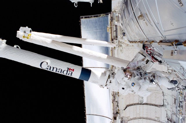Astronaut Scott E. Parazynski, mission specialist, works with cables associated with the Space Station Remote Manipulator System (SSRMS) or Canadarm2 during one of two days of extravehicular activity (EVA). Parazynski shared both space walks with astronaut Chris A. Hadfield of the Canadian Space Agency (CSA).